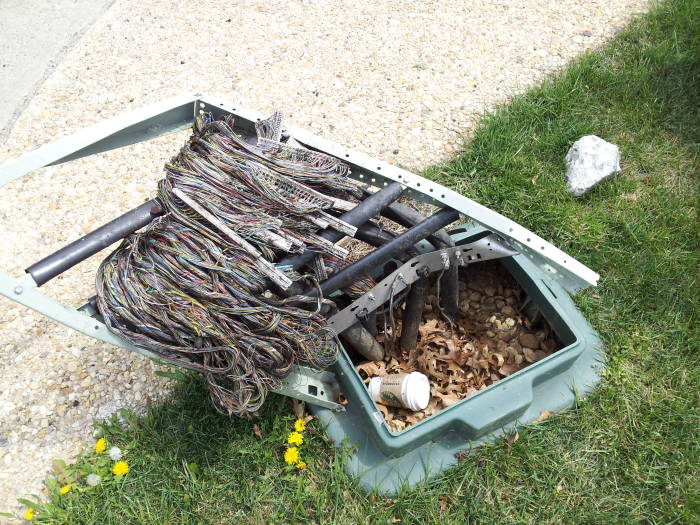 Telco pedestal smashed open by a car.