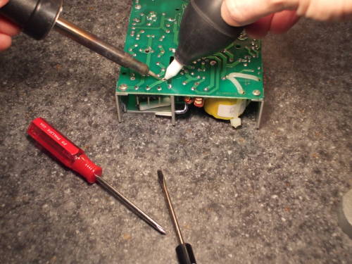 Desoldering the blown fuse.