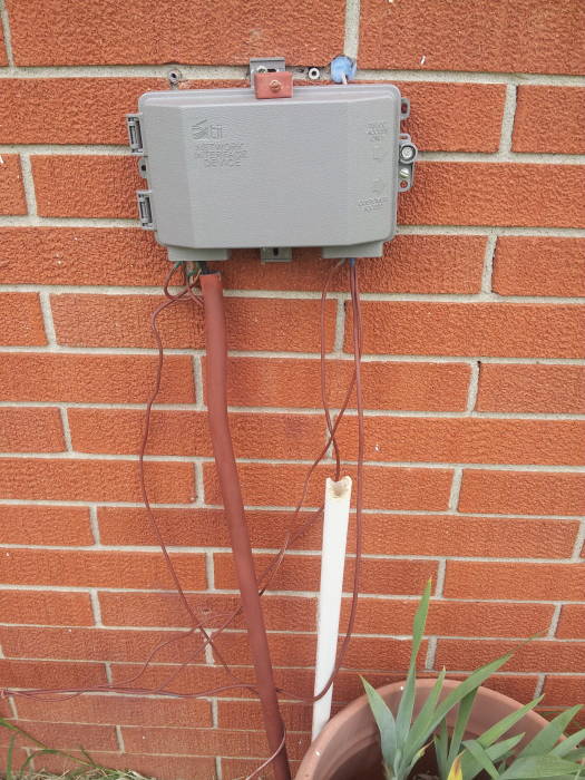 Network interface box on rear of house.