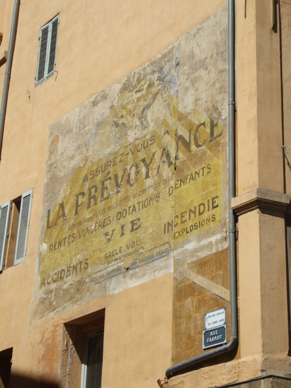 Old sign advertising insurance along Cours Mirabeau in Aix-en-Provence.