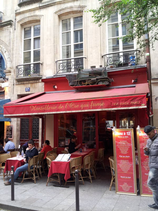 Café near Place Saint-Michel near the Seine River through Paris.