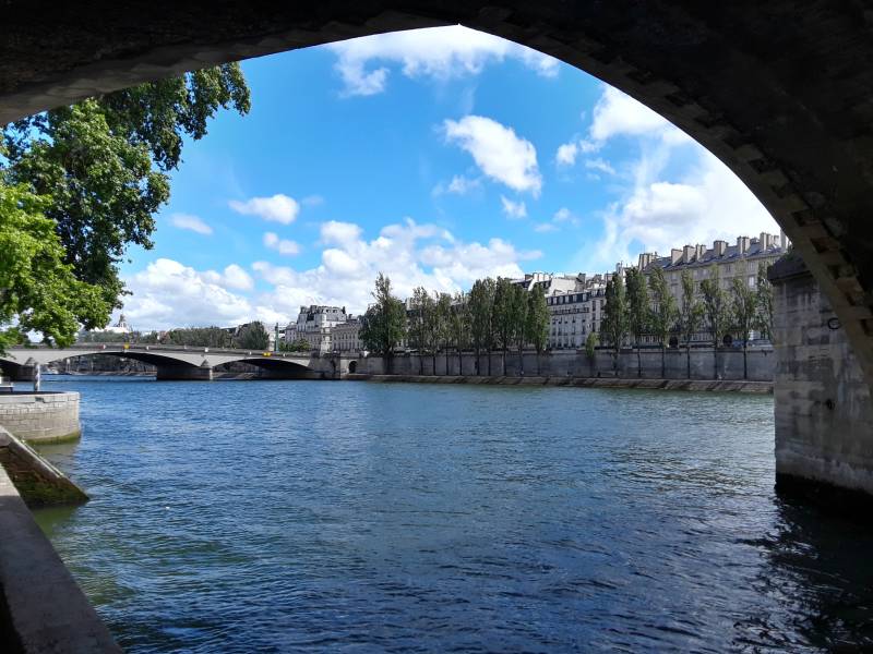 Passing under Pont Royal across the Seine River through Paris.