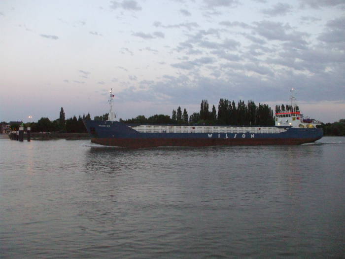 Ocean-going ship moving up the Seine river past Duclair.