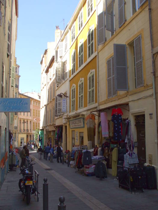 Small businesses along Rue des Petites Maries in Marseille.