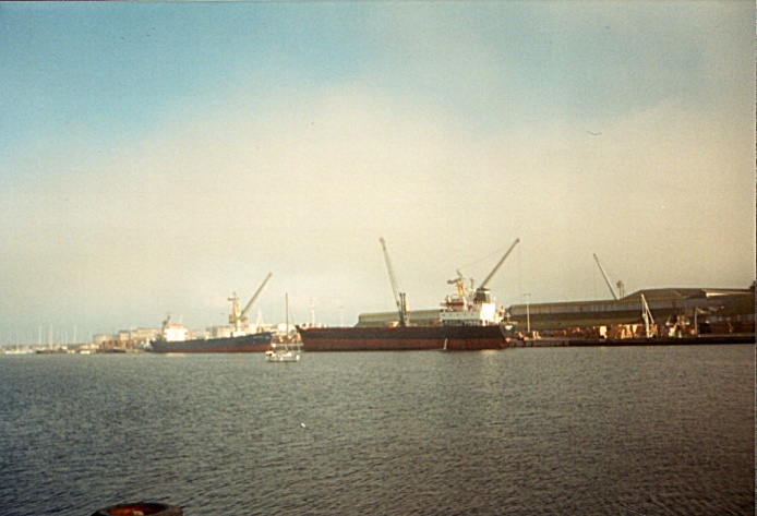 I look across the harbor and freight container ships from the Cap-Malo restaurant, bar, and hotel in Saint Malo, France.