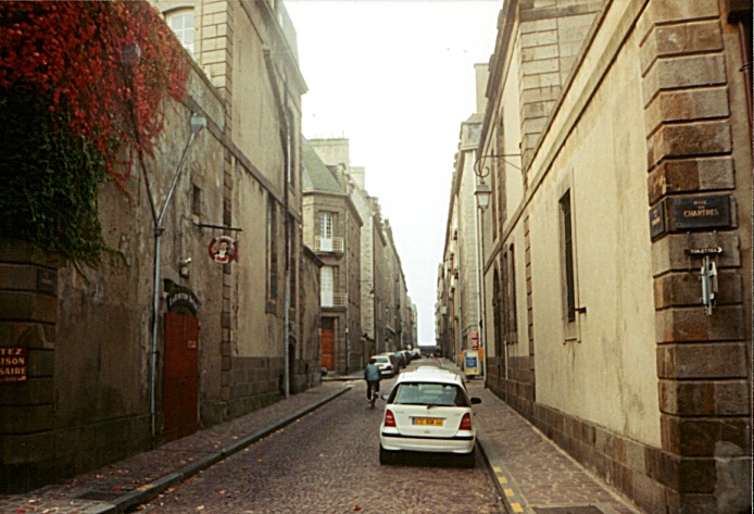 I walk within the walled old city in Saint Malo, France.