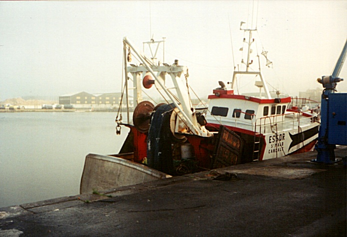 I look across the quay and a fishing boat in the harbor from the Cap-Malo restaurant, bar, and hotel in Saint Malo, France.