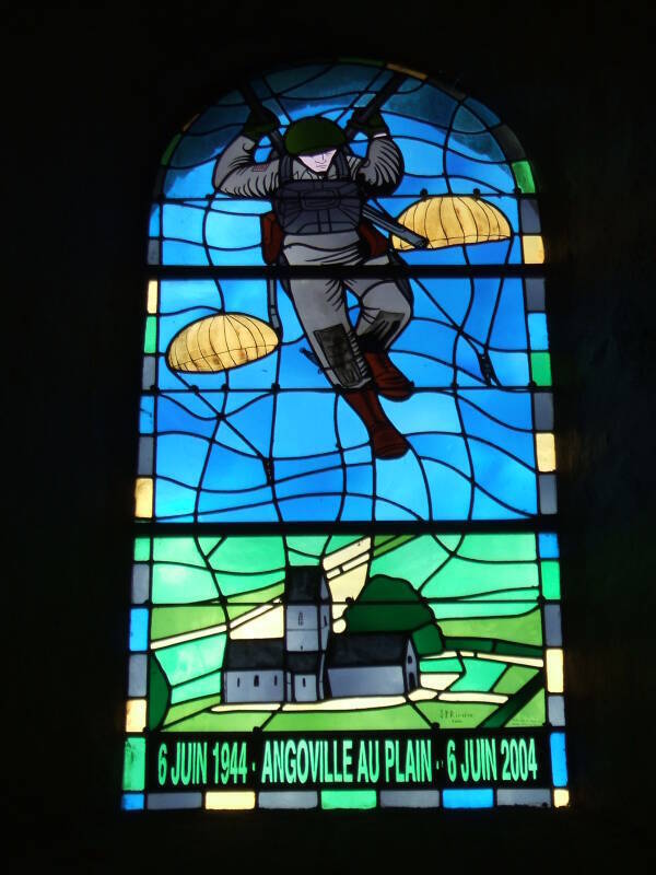 Stained glass window commemorating D-Day in the church at Angoville au Plain, in Normandy. U.S. paratroopers above the church, '6 Juin 1944 - Angoville Au Plain - 6 Juin 2004' below.