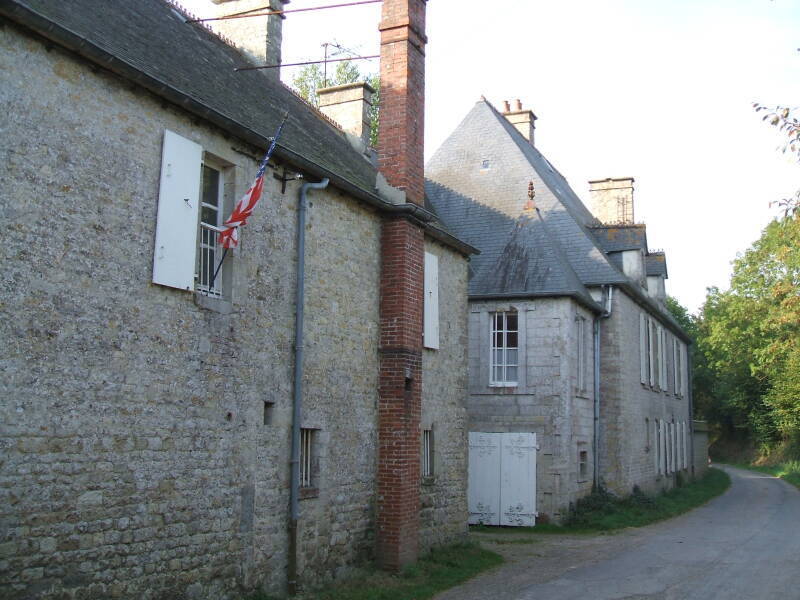 Brécourt Manor, just inland of Utah Beach. Narrow road, old stone barn and estate. D-Day battlefields surround it.
