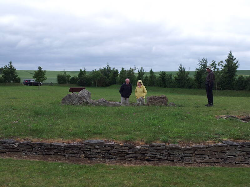 View to the southeast of people standing in the Pierre Tourneresse neolithic passage grave.