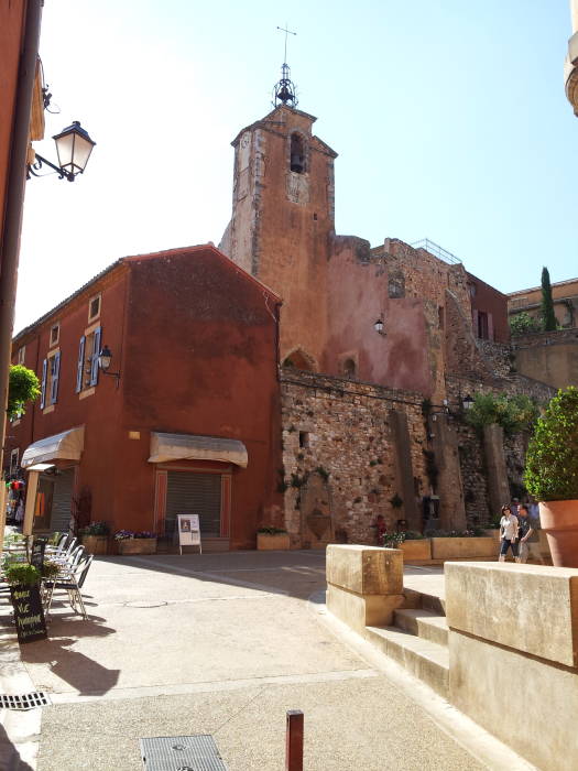 Roussillon central square by the Mairie, clock tower in the background.