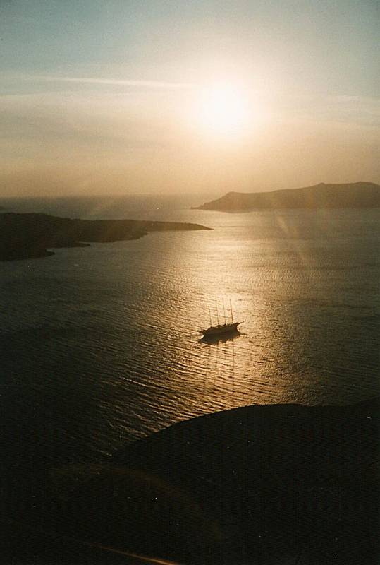 Sunset over Santorini as a cruise ship leaves for another Greek island.