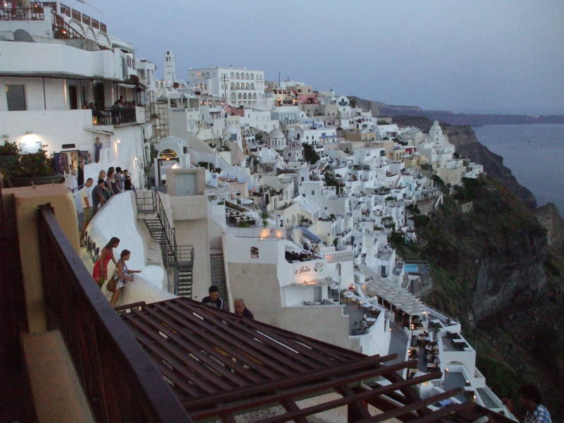 Lights come on after sunset on Santorini.