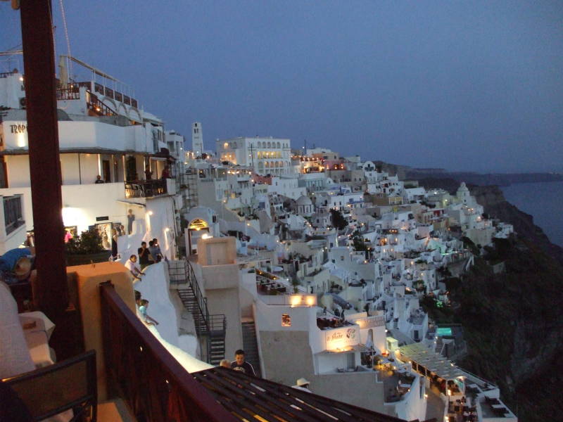 Lights come on after sunset on Santorini.