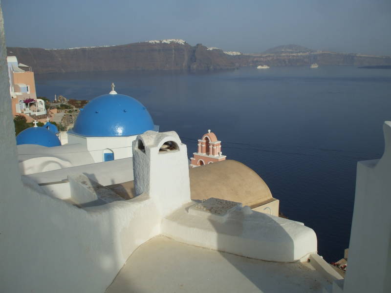 Blue domes and white walls in Oia, a small town on the Greek island of Santorini.