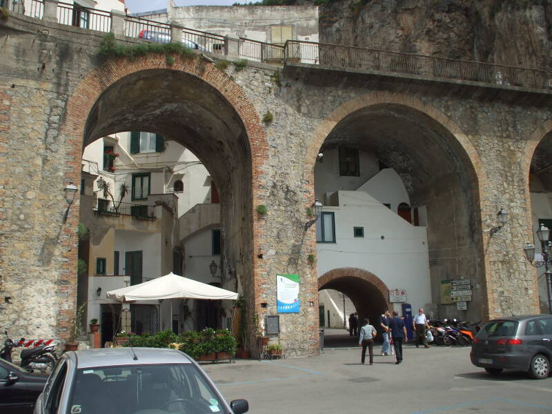 Down below the coast road, cutting through the archways.