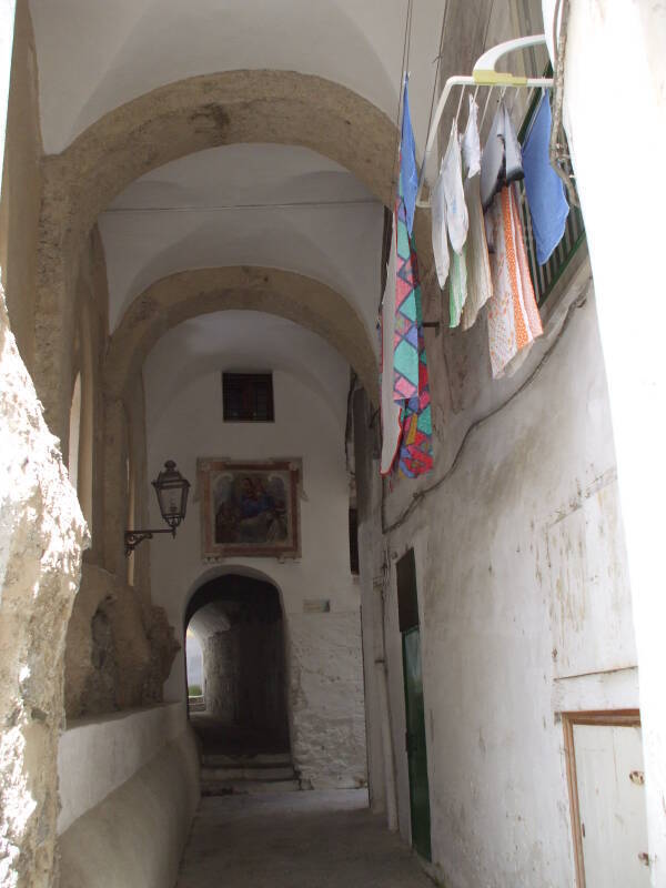 Into a narrow passageway along the road.