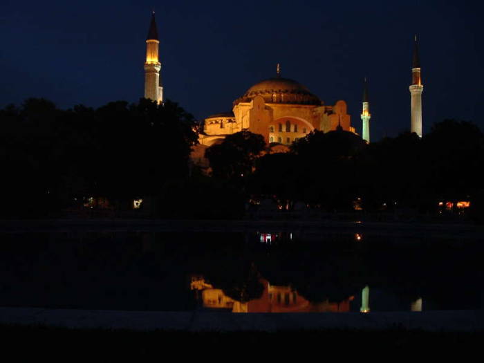 Exterior of the Hagia Sophia or Aya Sofya, in Istanbul. Night time view. Four large minarets around a large dome.