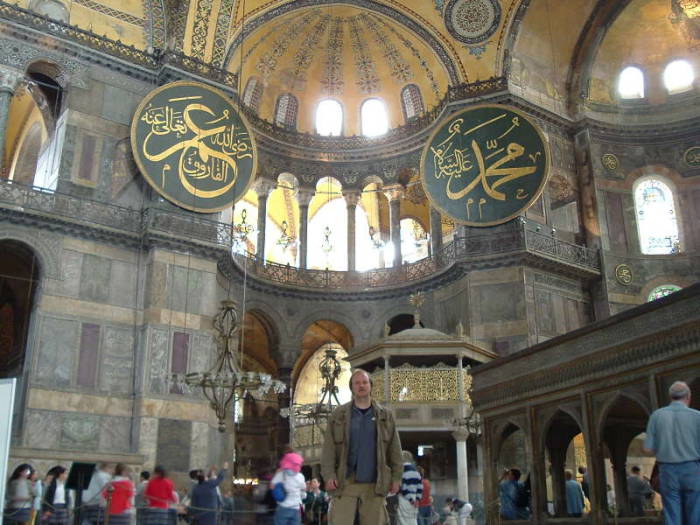 Interior of the Hagia Sophia or Aya Sofya, in Istanbul. Mosaic of the Virgin Mary and Jesus in a large semi-dome over the altar area. Mihrab showing the direction to Mecca. Minbar or pulpit from which the Imam delivers the sermon. Large medallions with Koranic quotes in large calligraphy.