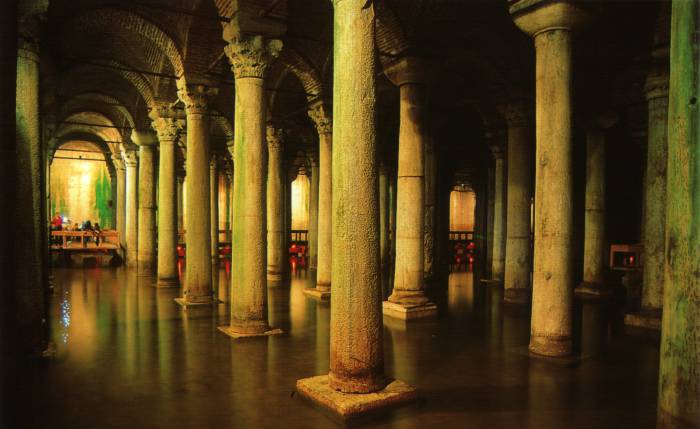 Basilica Cistern or Yerebatan Sarnıcı in Istanbul. Large marble columns, shallow water, stone arches.