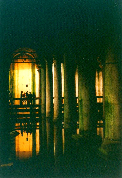 Basilica Cistern or Yerebatan Sarnıcı in Istanbul. Large marble columns, shallow water, stone arches.