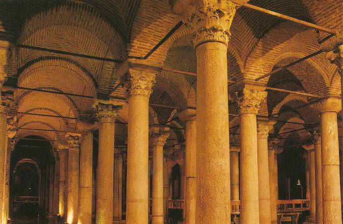 Basilica Cistern or Yerebatan Sarnıcı in Istanbul. Large marble columns, shallow water, stone arches.