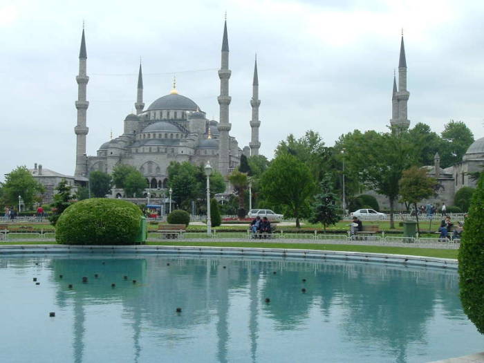 Blue mosque or Sultanahmet Cami, in Istanbul, with its six minarets and many domes. Daytime view with reflecting pool.