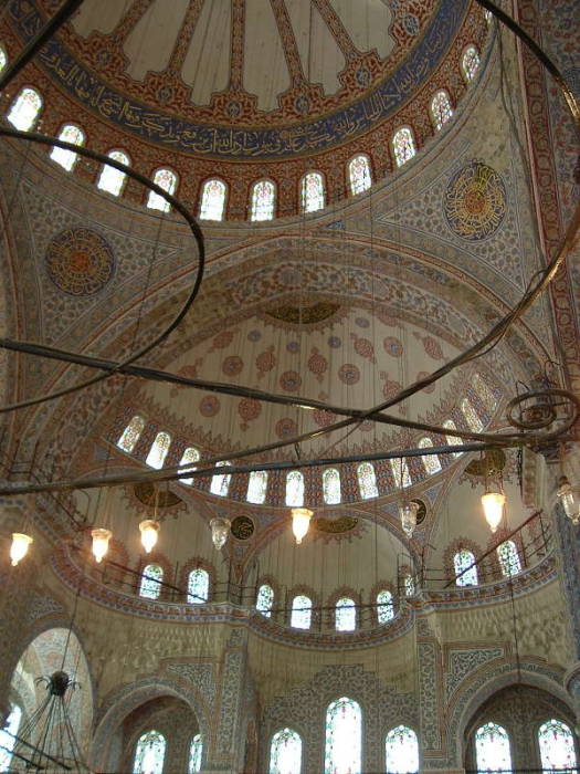Interior of the Blue mosque or Sultanahmet Cami, in Istanbul. Many domes and beautiful tile walls.