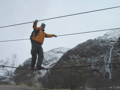Crossing a 3-wire bridge while trekking through Glen Nevis and the Water of Nevis.