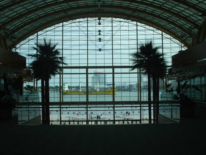 Looking out of Detroit Renaissance Center to Windsor, Ontario, with Great Lakes freighter passing down river.