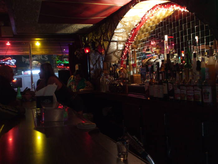 Cocktail waitress behind the bar at The Distinguished Wakamba Cocktail Lounge at 543 8th Avenue.