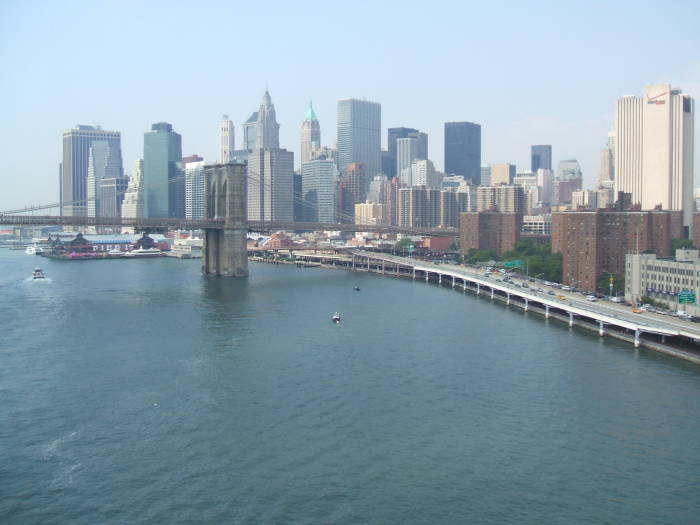 The Manhattan Bridge crosses the East River between Manhattan and Brooklyn, passing high above the FDR Drive.