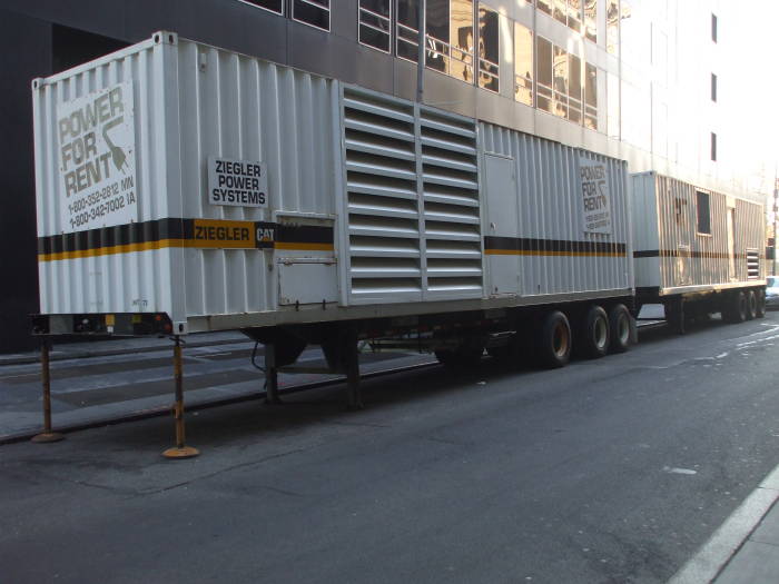 Electrical power generators stand in a line.