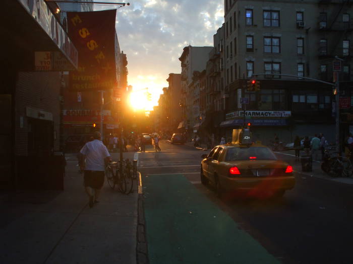 Near Manhattanhenge sunset over Rivington Street at Essex Street.