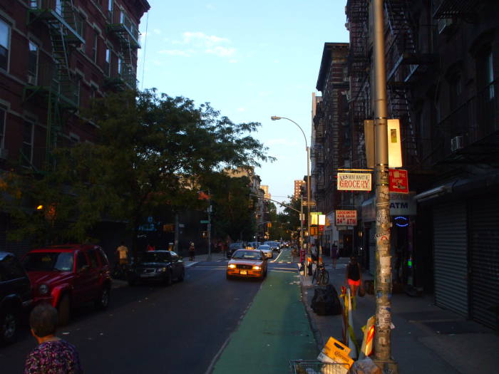 Near Manhattanhenge sunset on Rivington Street between Essex and Norfolk.