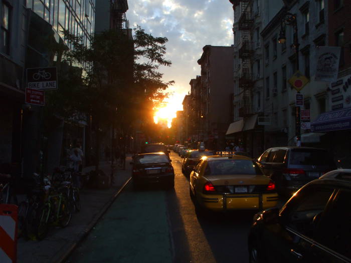 Near Manhattanhenge sunset over Rivington Street between Essex and Ludlow.