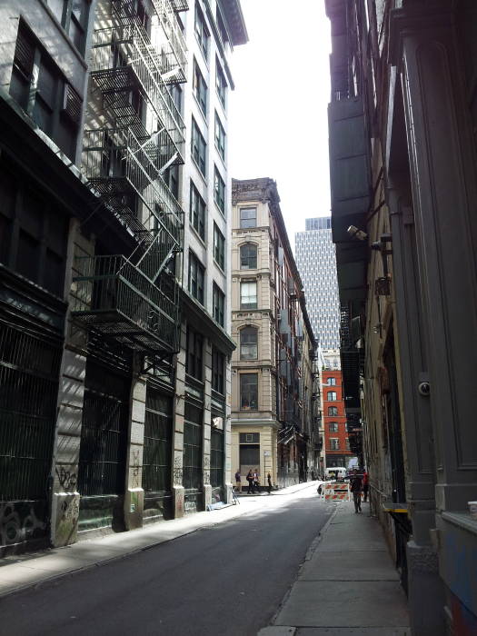 Fire escapes lead down to Cortlandt Alley, the Mudd Club is visible at the end at White Street.