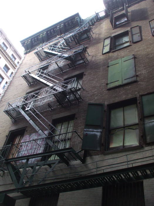 Fire escapes lead down to Cortlandt Alley.