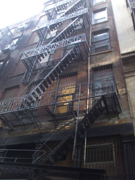 Fire escapes lead down to Cortlandt Alley.