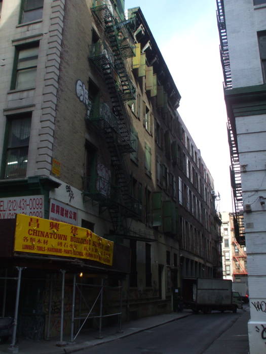 A man walks along Cortlandt Alley.