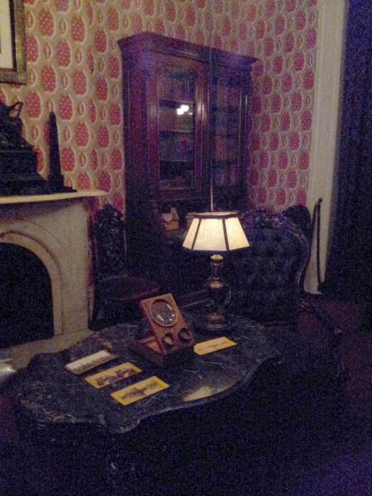 Library with gas lights and horsehair chairs within Theodore Roosevelt's birthplace in New York.
