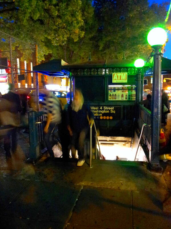 Blurred people entering and exiting the West 4th Street Washington Square Station on the New York MTA.