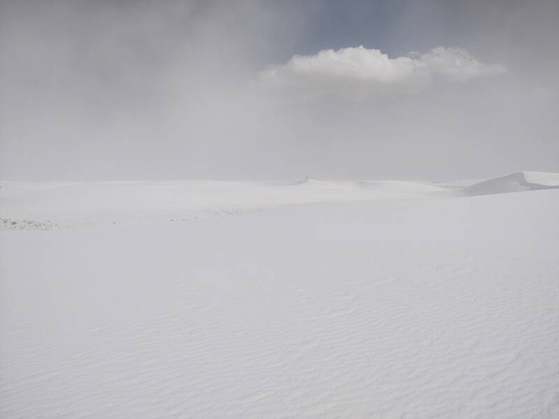 Trail marker pole barely visible at White Sands.