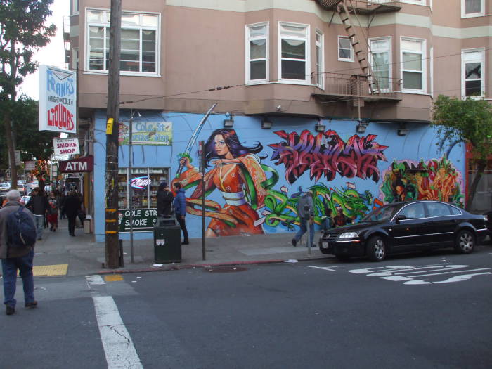 Colorful mural of a warrior woman on a mini-mart.  Haight Street, between its west end at Golden Gate Park and Mission Street.