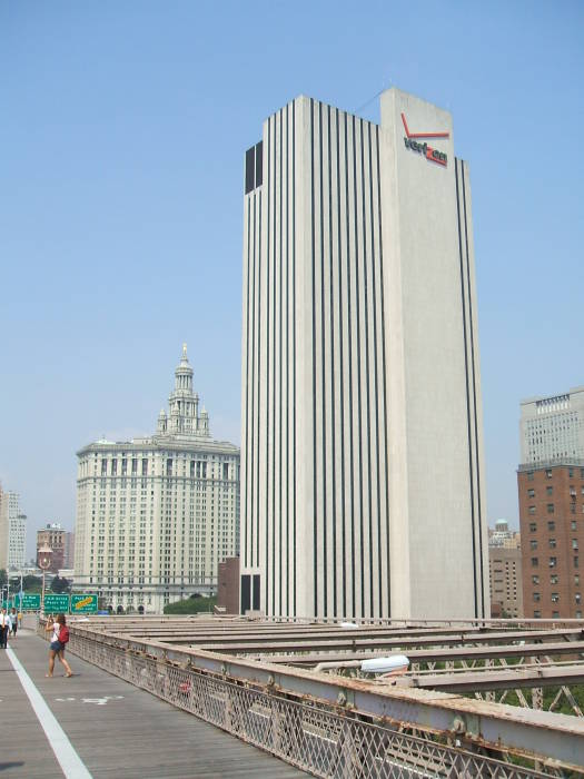 We can clearly see the Verizon logo on the largely featureless tower at 375 Pearl Street in lower Manhattan as we cross the Brooklyn Bridge.